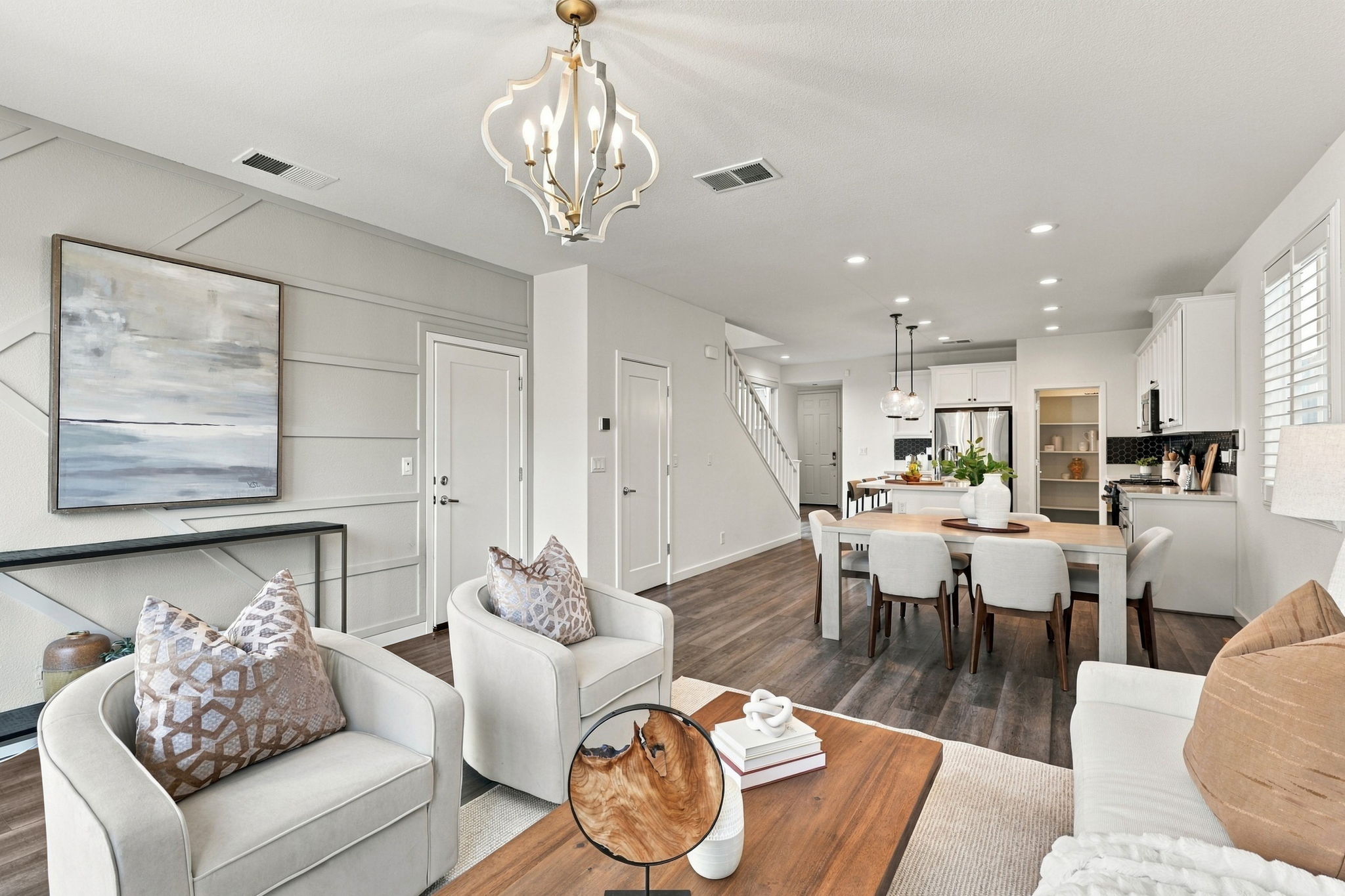 1230 Qualteri Way - Living room with chandelier, open to the dining area and kitchen