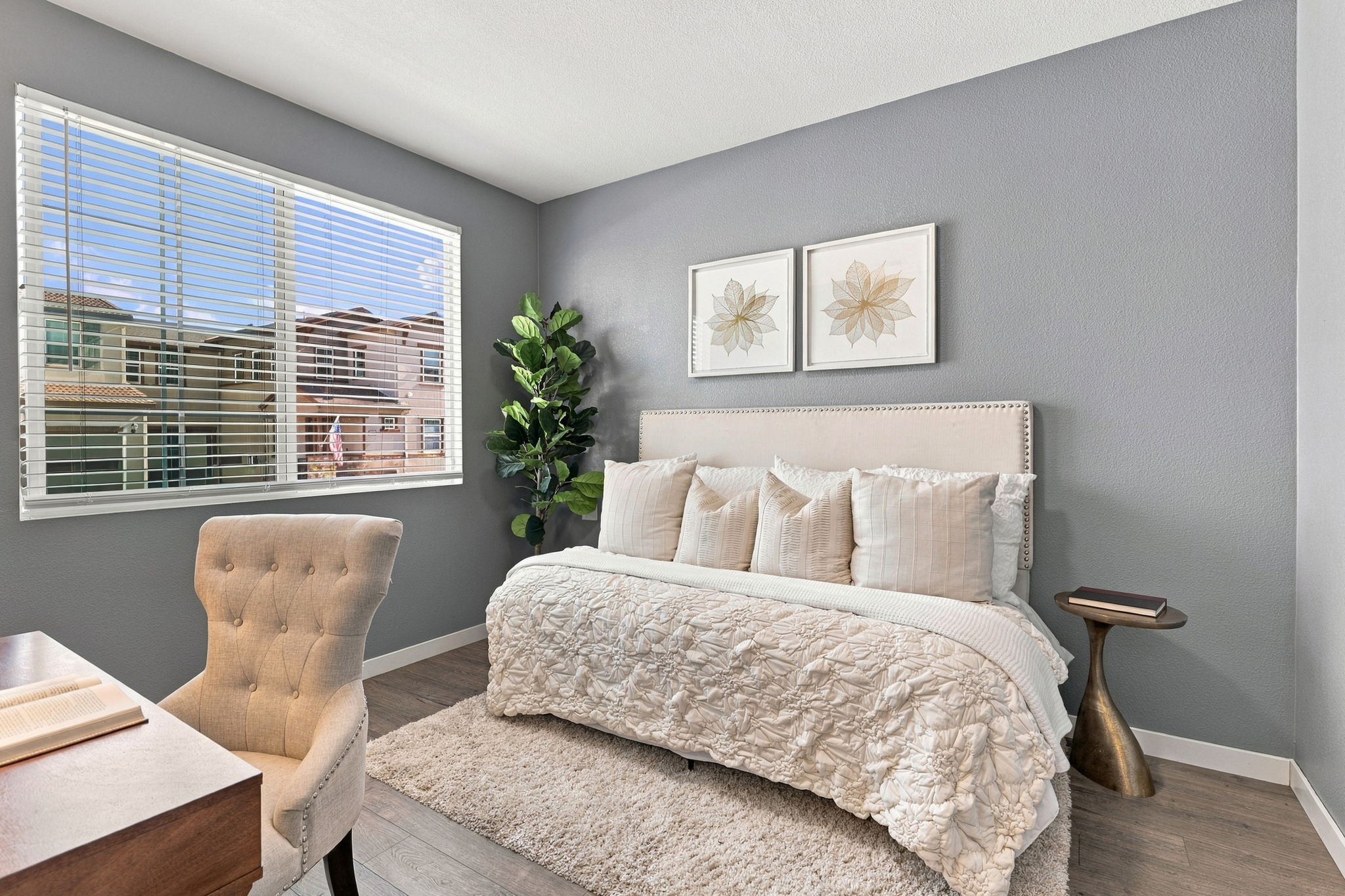1230 Qualteri Way - Primary bedroom with gray accent wall and sitting chair